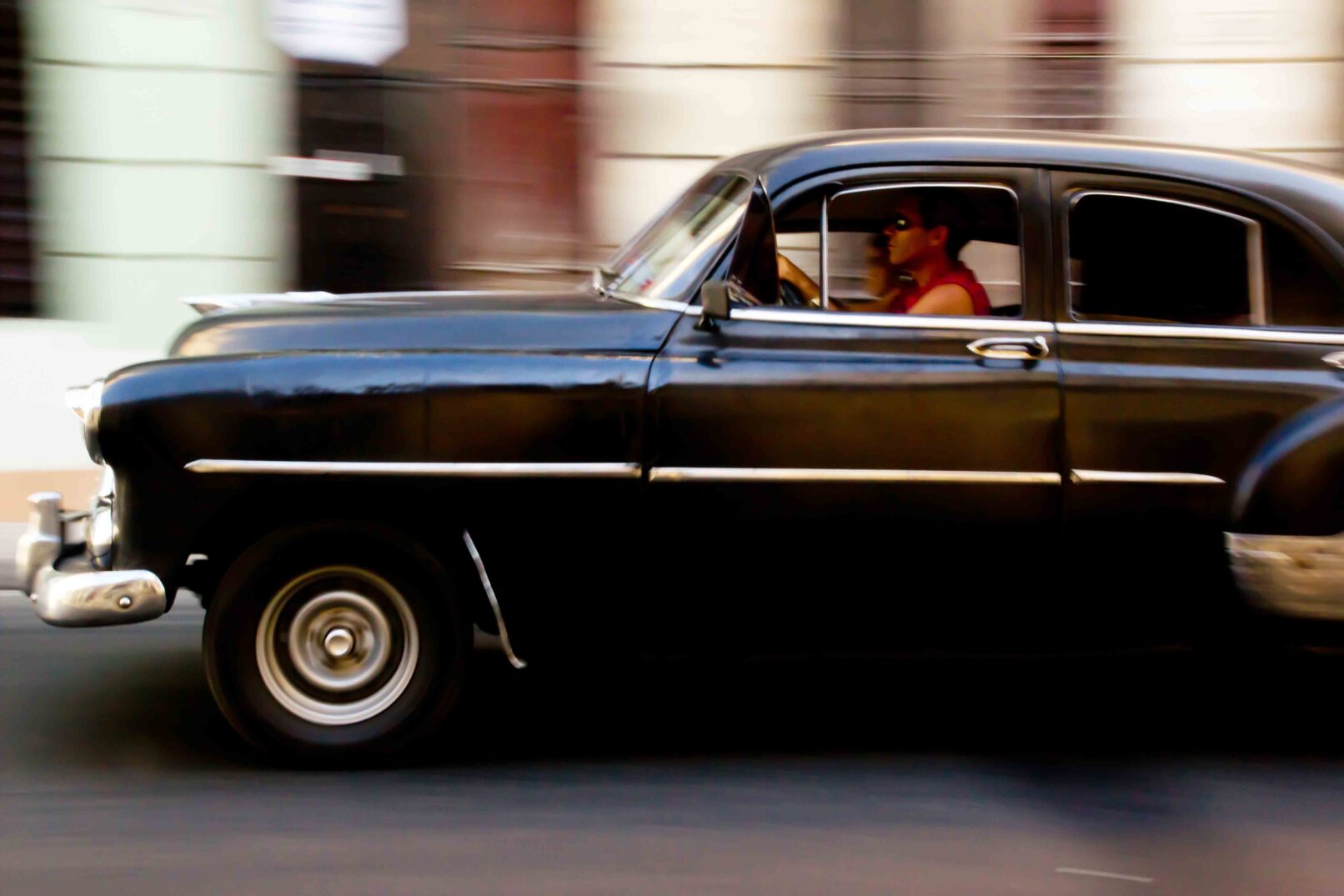 Driving a classic car in Havana Vieja, Cuba